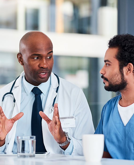 Two healthcare professionals having a discussion at a table